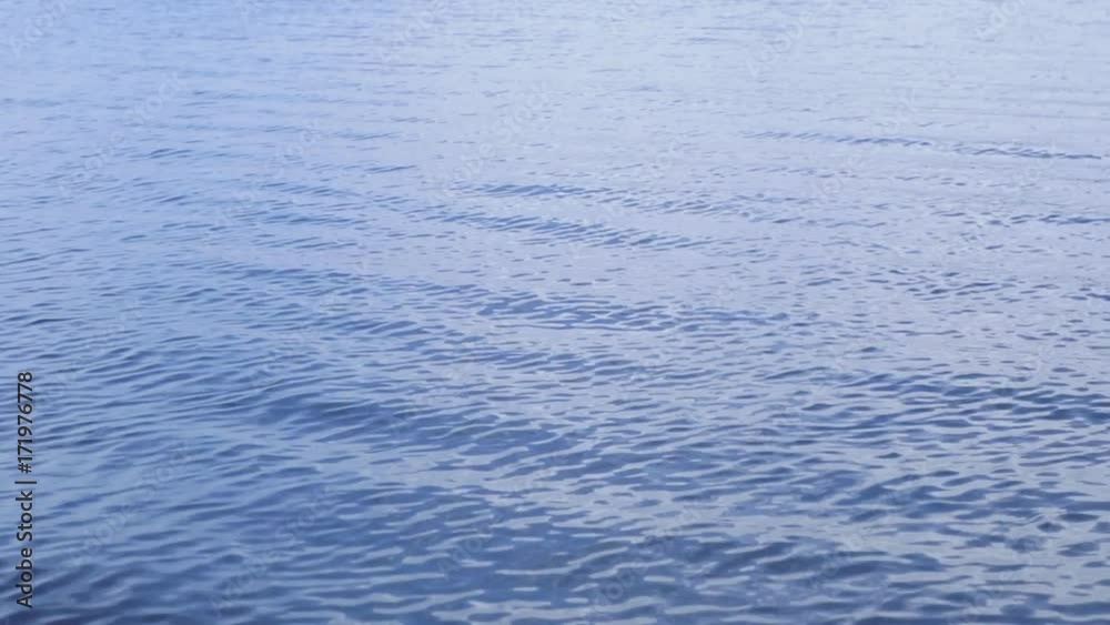 Abstract background of river or lake water surface with glittering with wave in dark blue tone evening. Abstract background of river or lake water surface with glittering with wave in dark blue tone evening.
