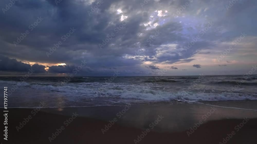 Clouds crossing the blue sky above the sea on twilight. Time lapse, wide angle.