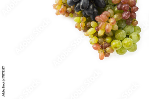 Grapes on white background. Grapes with copy space for text. Top view. Blue, red and green grapes. Vegetarian or healthy eating.