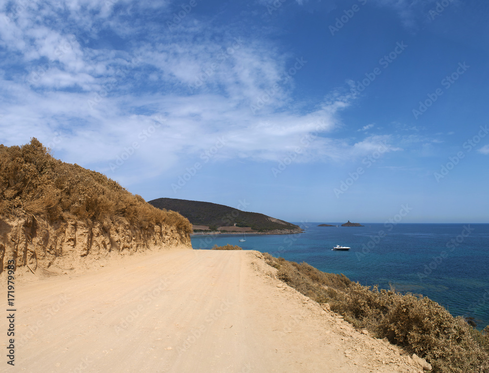 Corsica, 28/08/2017: la strada sterrata che porta alla spiaggia di Tamarone, una delle più famose e selvagge del Cap Corse, circondata dalla macchia mediterranea