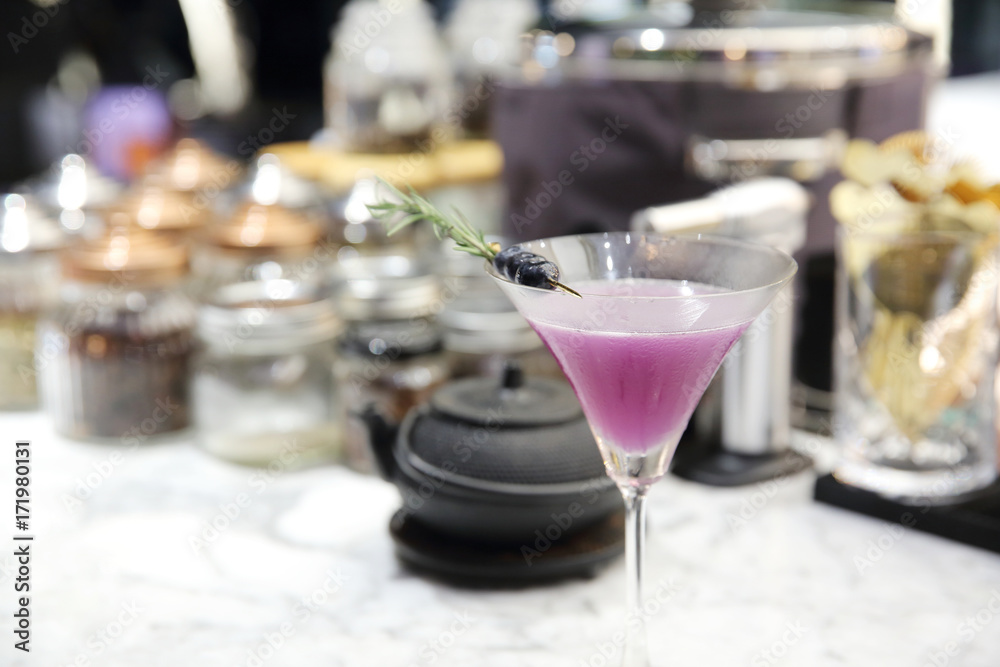 Purple cocktail on bar background