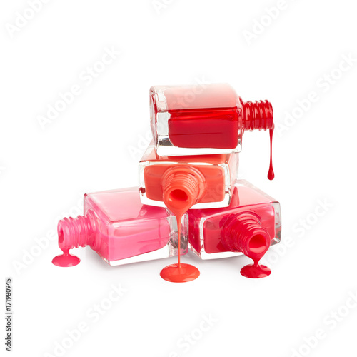 Stack of bottles with spilled nail polish isolated on white background