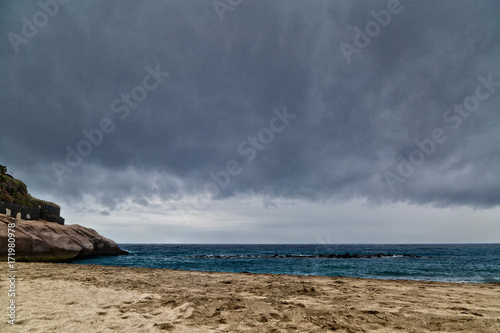 tropical beach under gloomy sky