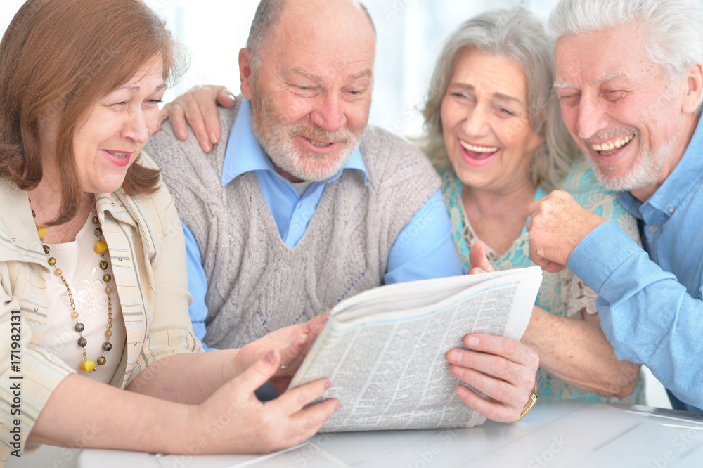 senior couples reading newspaper senior couples reading newspaper