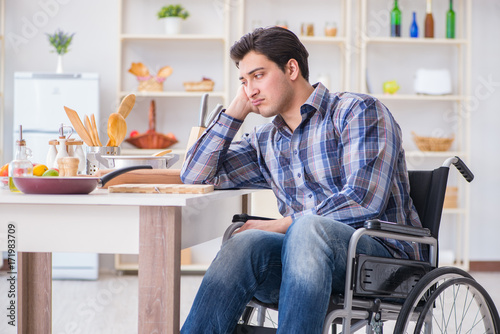 Disabled young man husband working in kitchen