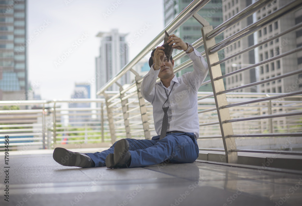 business, teamwork, people and crisis concept, business man sitting sad and solving problem outdoor. business, teamwork, people and crisis concept, business man sitting sad and solving problem outdoor.