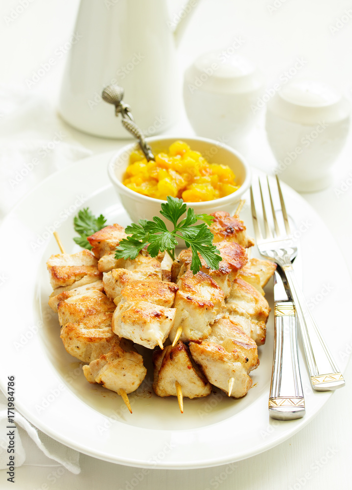 chicken skewers with apple-apricot chutney. Selective focus. chicken skewers with apple-apricot chutney. Selective focus.