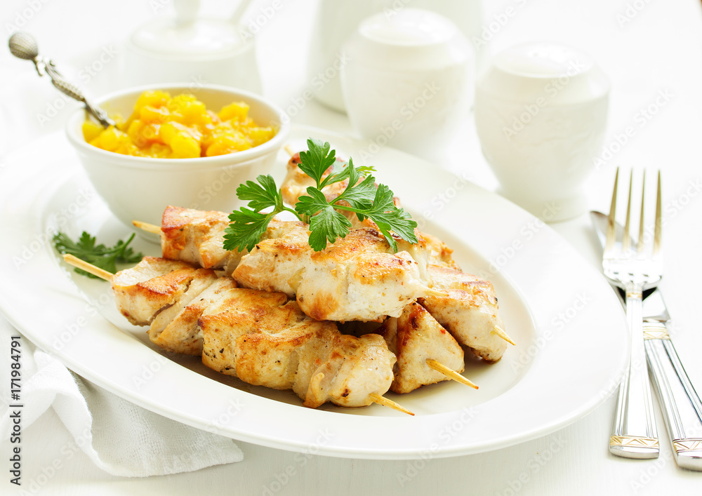 chicken skewers with apple-apricot chutney. Selective focus. chicken skewers with apple-apricot chutney. Selective focus.