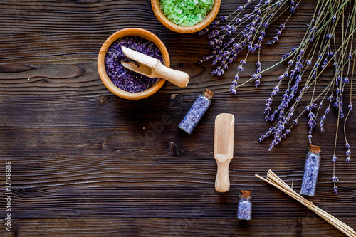 home spa with lavender herbs cosmetic salt for bath on wooden desk background top view mock-up
