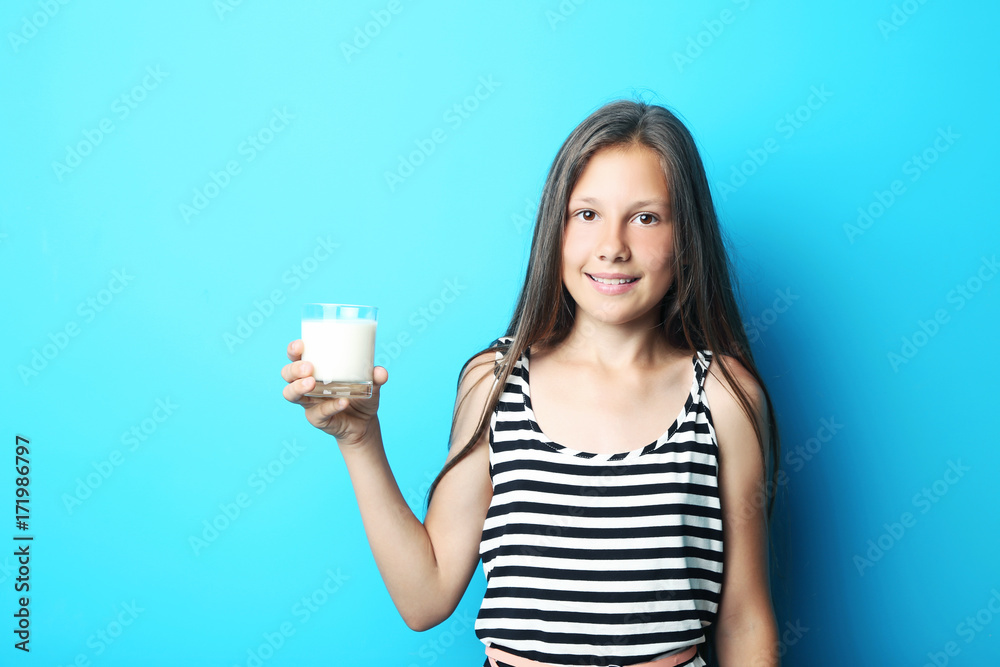 Portrait of beautiful girl with glass of milk on blue background Portrait of beautiful girl with glass of milk on blue background