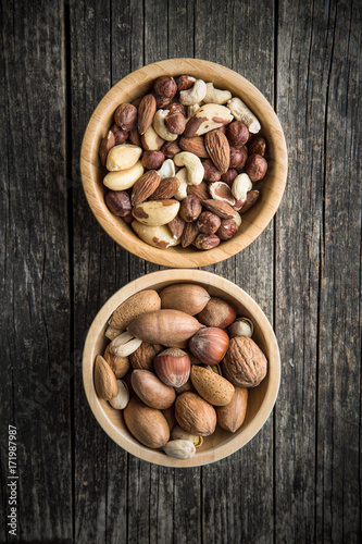 Different types of nuts in wooden bowl.