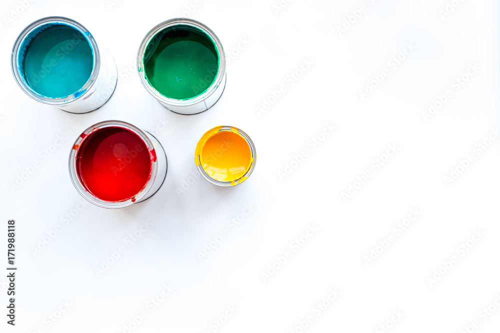 Paints in tin banks on white background top view copyspace Paints in tin banks on white background top view copyspace