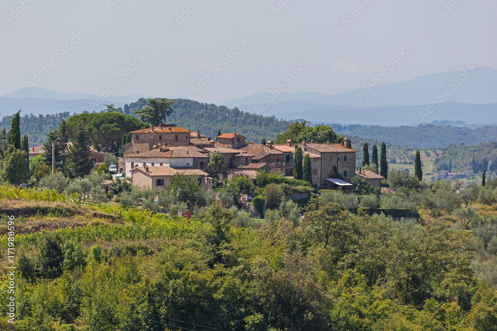 Typical Tuscany village is surrounded by picturesque hills in the Chianti region, Tuscany, Italy