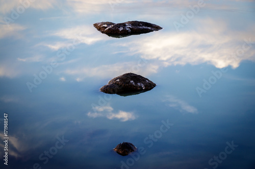 Reflection of a few rocks in the dried out lake Padulu Tortu on the island of Corsica.