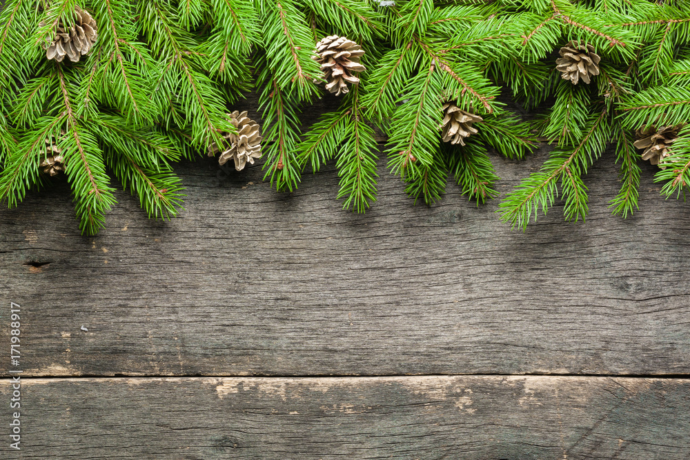 New Year and Christmas background on an old gray wooden background. View from above. Christmas tree branches and snow, gifts and decorations. New Year and Christmas background on an old gray wooden background. View from above. Christmas tree branches and snow, gifts and decorations.