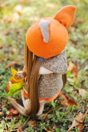 Wallpaper Mural handmade doll girl in orange dress holding fox, mushrooms and acorn in the background of autumn foliage. Autumn. Torontodigital.ca