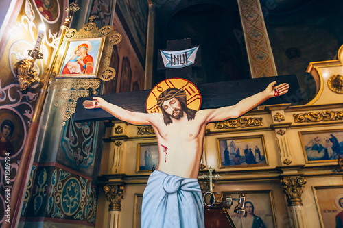 Wall Mural crucifixion of Jesus Christ on the background of the altar in the church or the cathedral, symbol of God's love,symbol of christian religion and belief