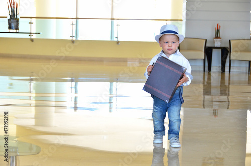 Baby traveler with a suitcase