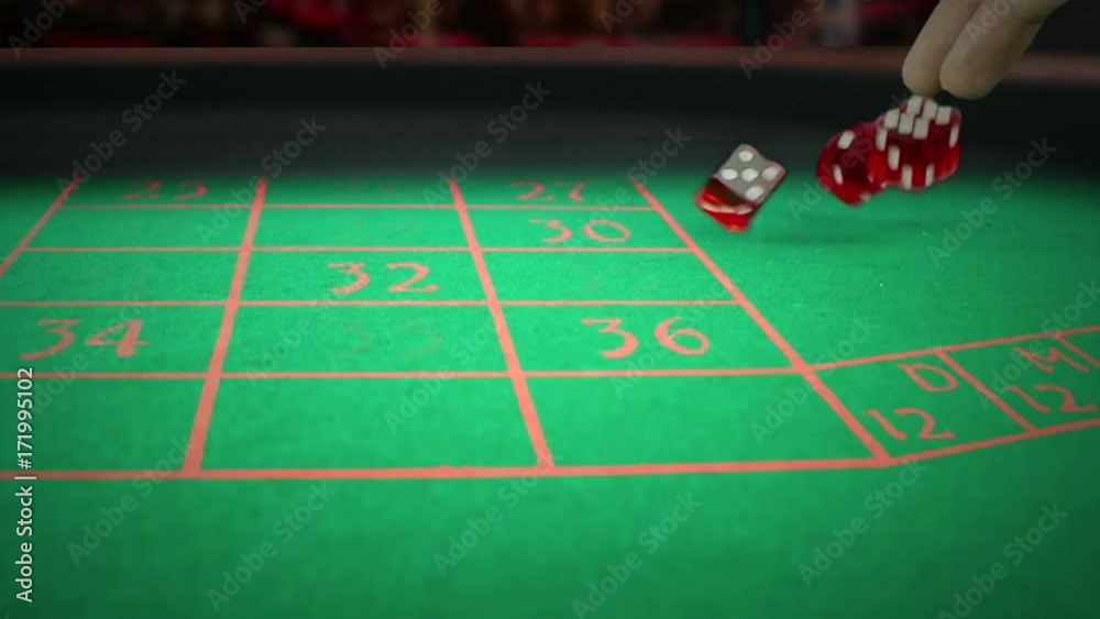 three red dice rolling on green game gambling table on light disco, shooting with slow motion, concept of sport recreation leisure game in the casino three red dice rolling on green game gambling table on light disco, shooting with slow motion, concept of sport recreation leisure game in the casino