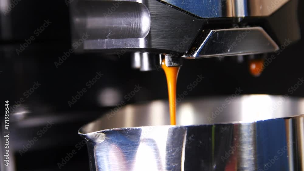 Macro Slow Motion Espresso Pours out in Metal Cup