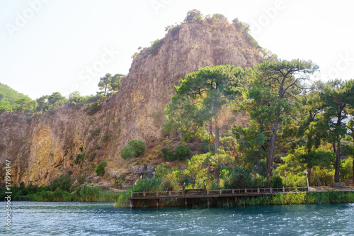 Amazing view of river and huge cliff on sunny summer day