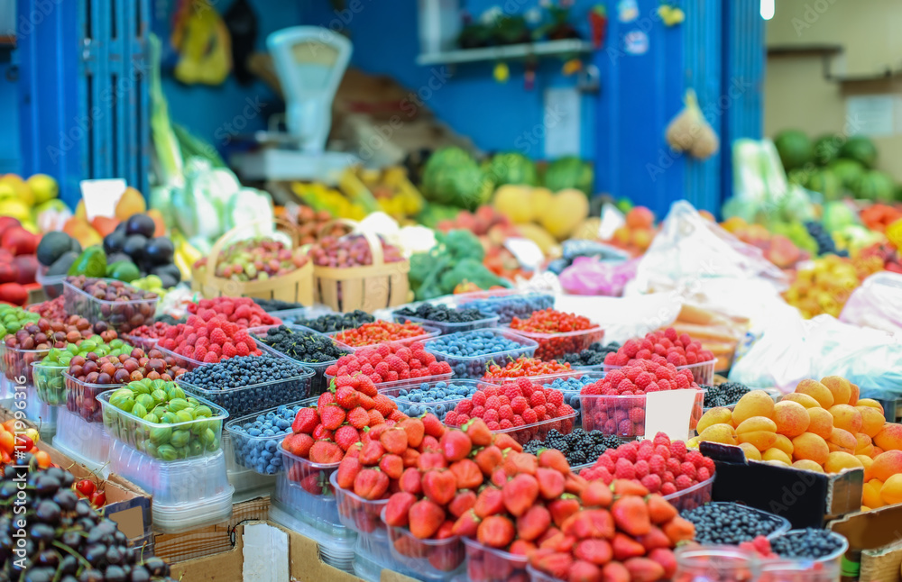 Assortment of fresh berries and fruits at market