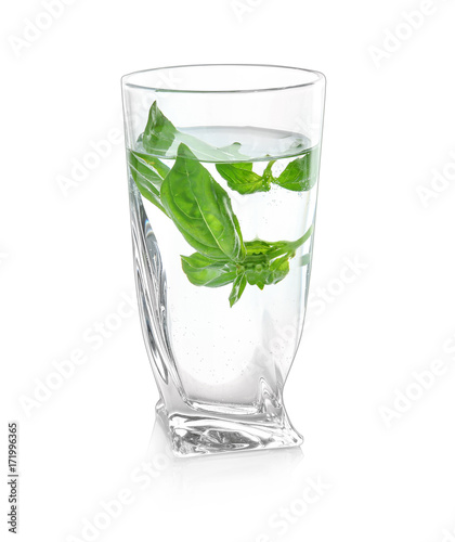 Glass with basil water, isolated on white