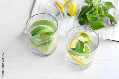 Basil water in glassware on table