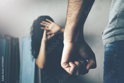 Man beating up his wife illustrating domestic violence