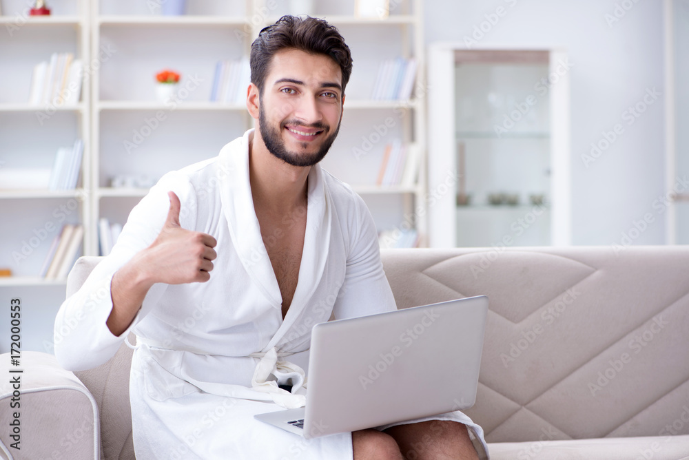 Young man freelancer working from home on a laptop Young man freelancer working from home on a laptop