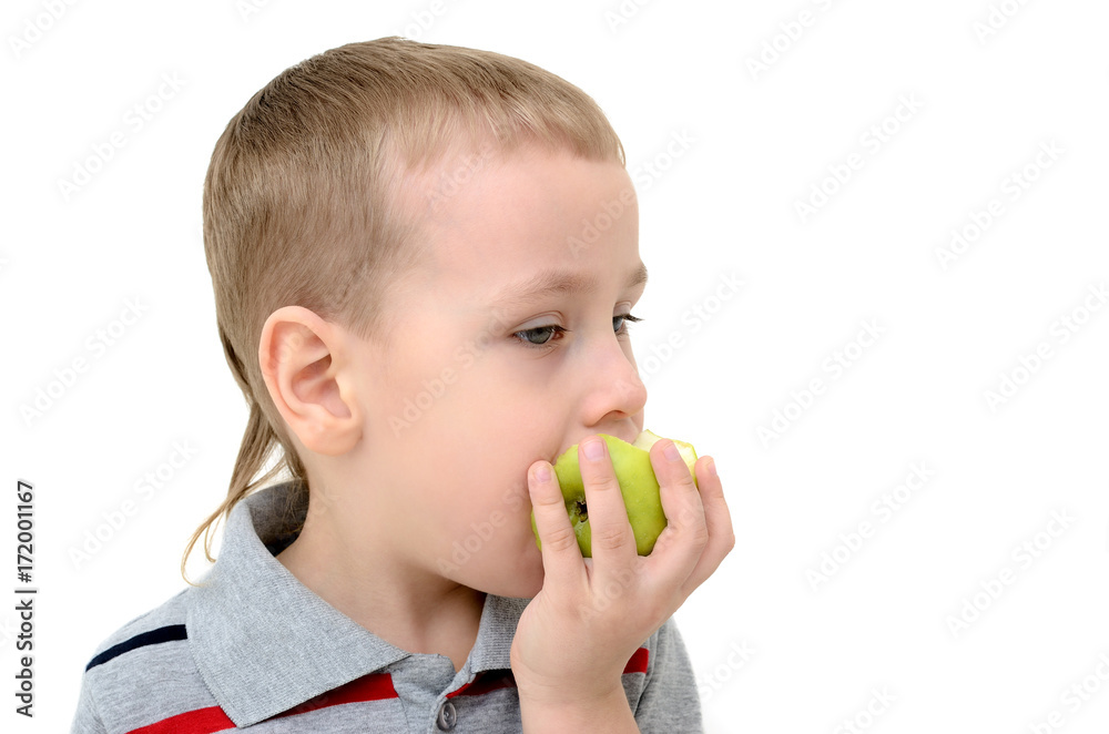Boy eating an apple on a white background Boy eating an apple on a white background