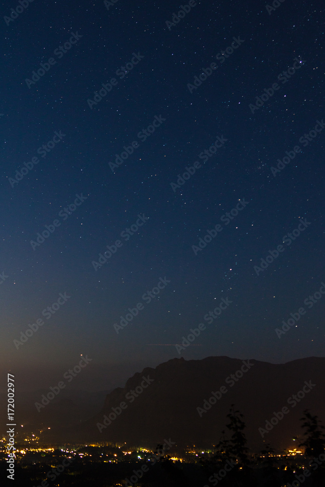Fototapeta premium Nightscape of North Bend beneath Mt. Si and stars, from Rattlesnake Ledge