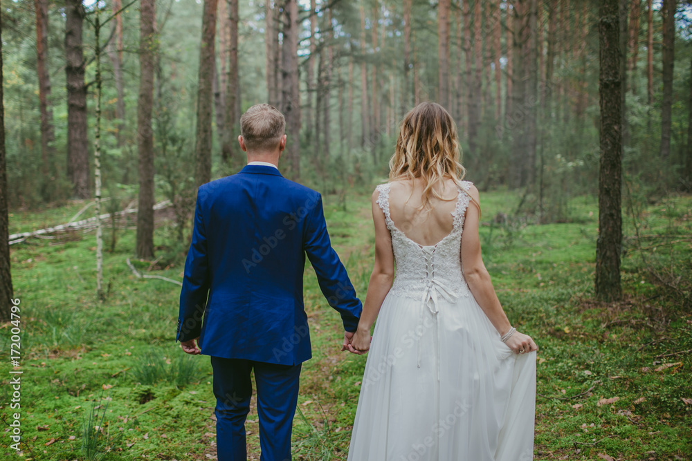 Bride and groom walking in the forest after wedding. Bride and groom walking in the forest after wedding.