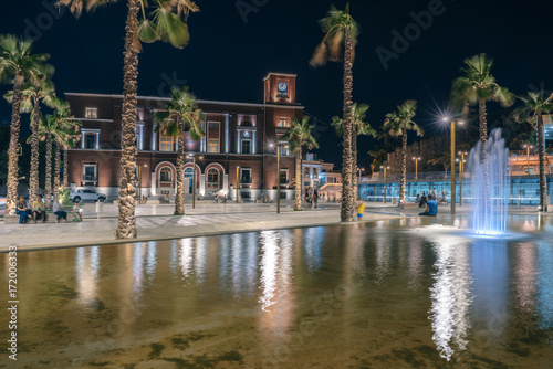 Evening central square with fountains  colorful lighting and city council are located on the square