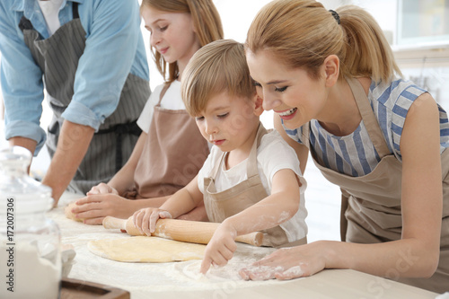 Family cooking in kitchen. ...