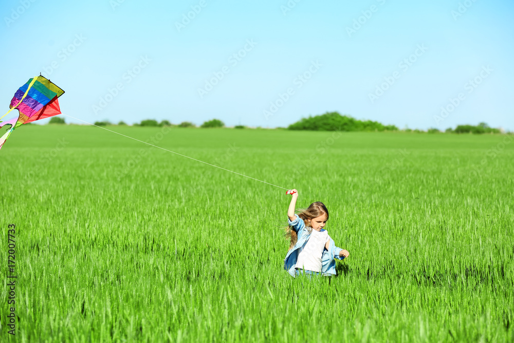 Happy little girl with kite in green field Happy little girl with kite in green field