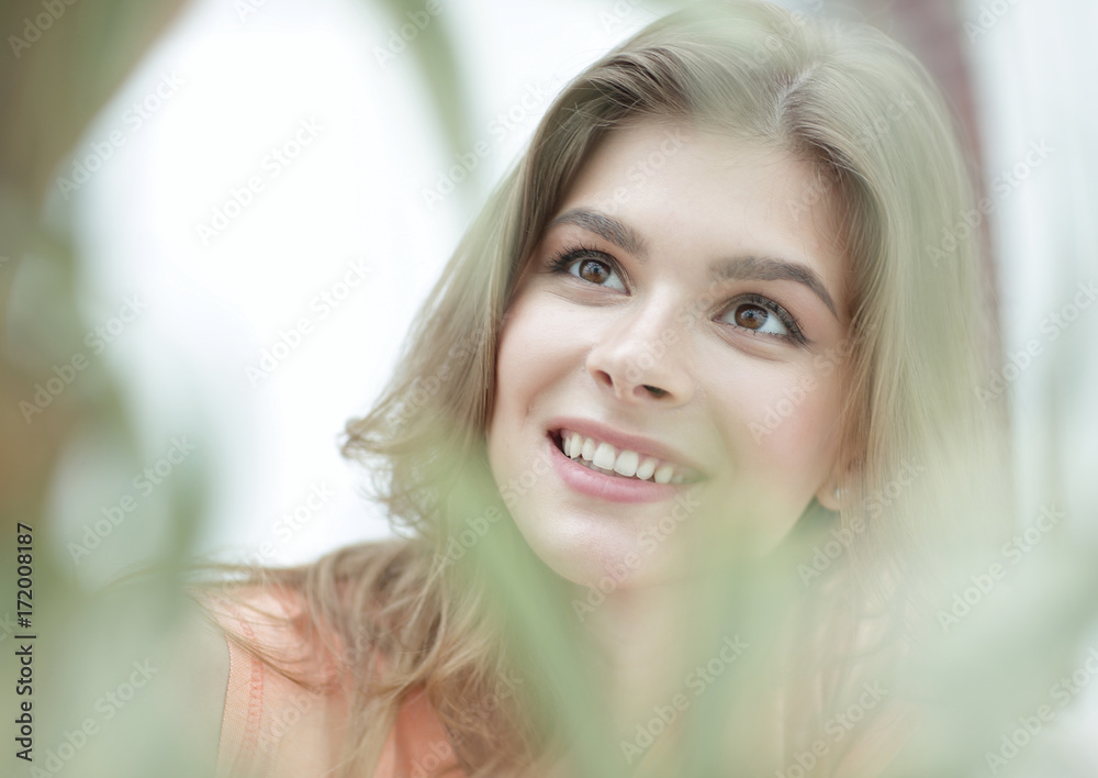 portrait of smiling woman face on blurred background. portrait of smiling woman face on blurred background.