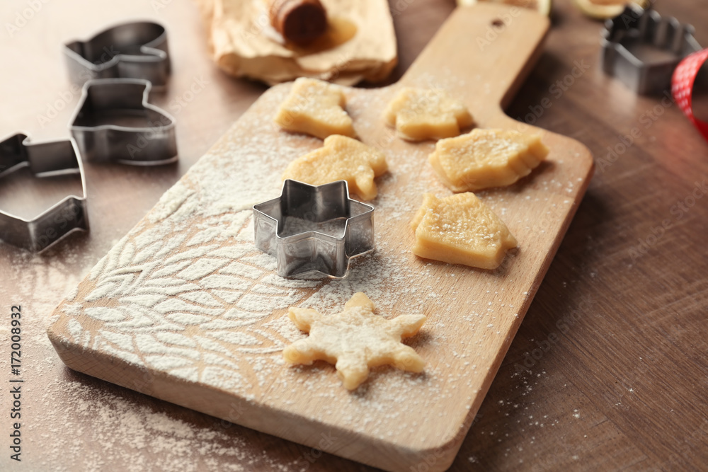 Christmas composition with raw cookies and cutters on wooden table Christmas composition with raw cookies and cutters on wooden table