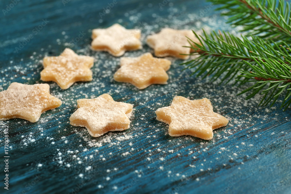 Christmas composition with raw cookies and fir tree branch on dark background