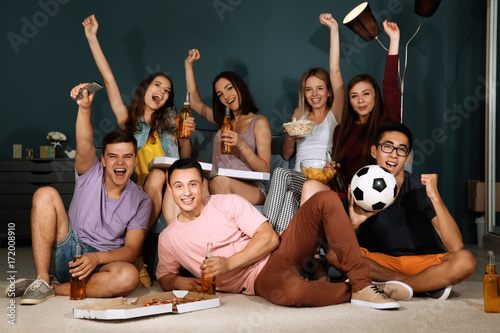 Friends watching TV in even...
