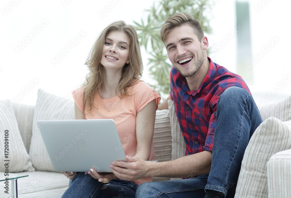 smiling couple resting at home,sitting on the couch. smiling couple resting at home,sitting on the couch.