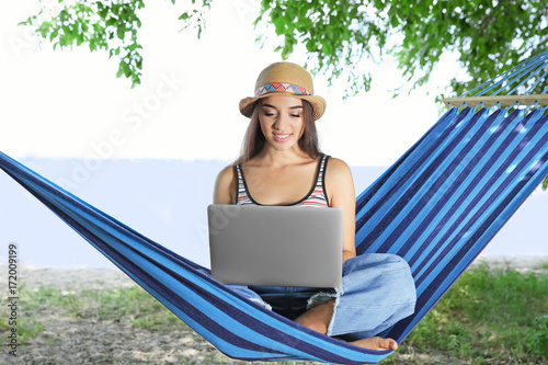 Young woman with laptop in ...
