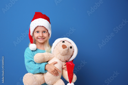 Cute girl in Santa hat with...