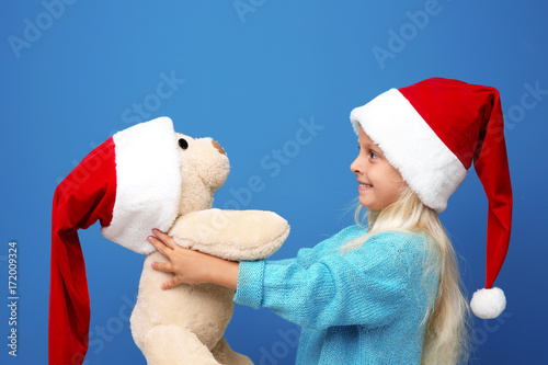 Cute girl in Santa hat with...