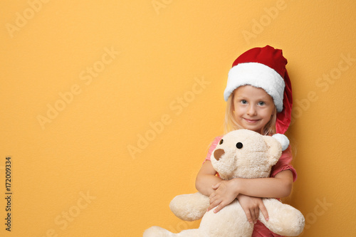 Cute girl in Santa hat with...