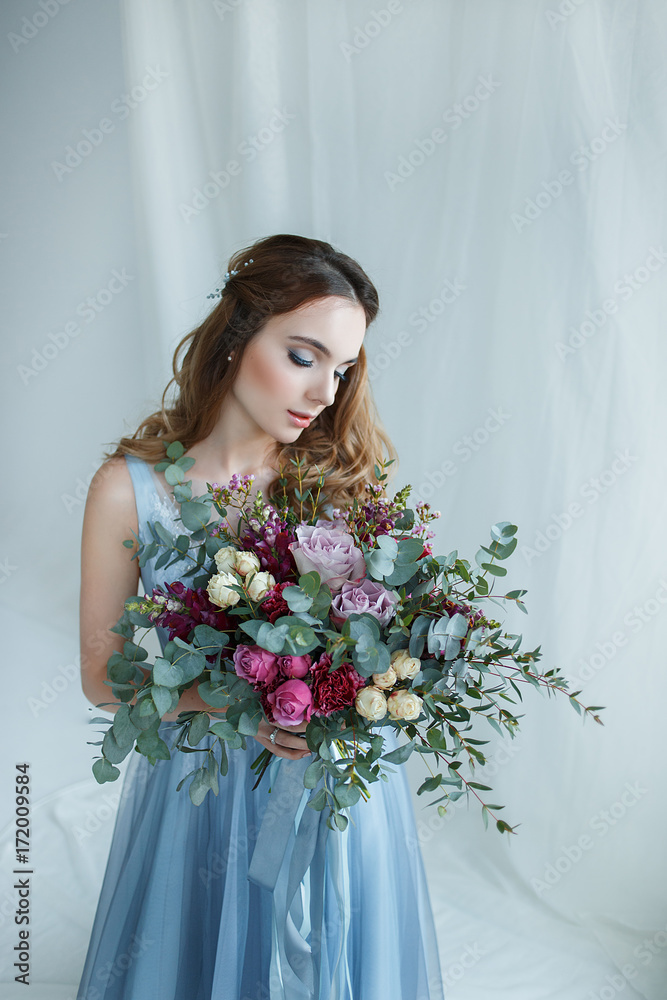bride in an blue gown with bouquet