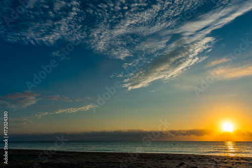 morning sun and blue sky over the ocean on a calm morning