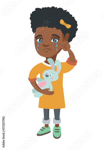 African-american girl crying and wiping the tears away. Little girl crying and holding toy rabbit in hand. Vector sketch cartoon illustration isolated on white background.