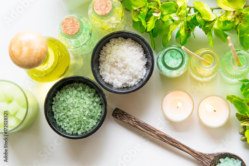 Thai Spa Treatments aroma therapy  salt and nature green sugar scrub and rock massage with green orchid flower on wooden white with candle. Thailand.  Healthy Concept. copy space,select and soft focus