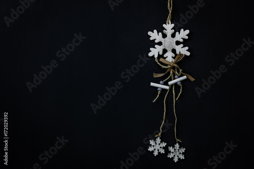 Table top view of decoration sign Merry Christmas and Happy new year background concept.the snowflakes handmade by wood.Object on the modern black wood home office.Free space for design text or word.